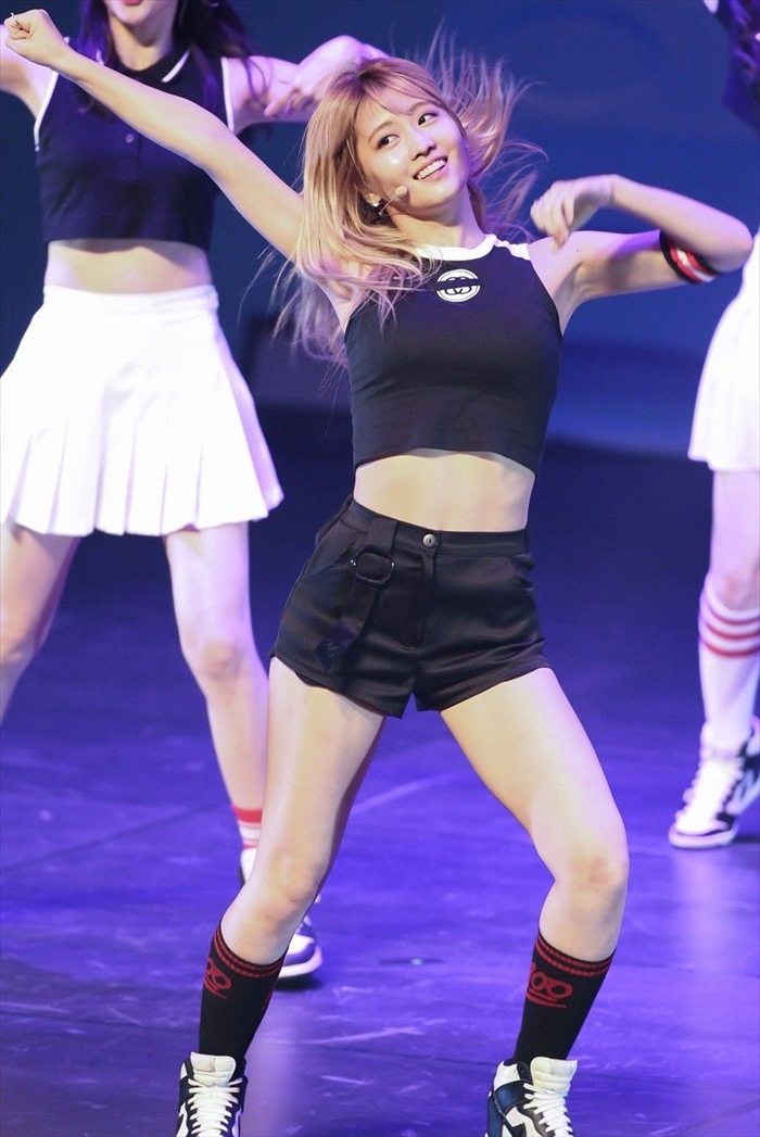 TWICE members in chic, form-fitting outfits, commanding the stage at their 2025 Japan concert.
